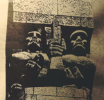 Zdjęcie czarno-białe. Zbliżenie na Pomnik Obrońców Wybrzeża. Dwie postaci wykute w kamieniu.