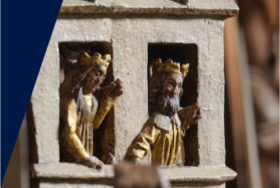 Zdjęcie. Fragment rzeźby św. Jerzego. Dwie postaci, król i królowa, wyglądają przez okna.